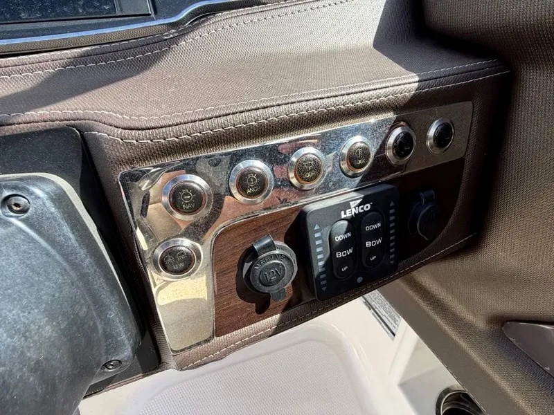 Slide: The Image of Close-up of a boat control panel with buttons and switches, including Lenco controls. - 16