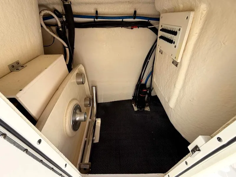 Slide: The Image of A clean storage area inside a boat with cables and a control panel. - 21
