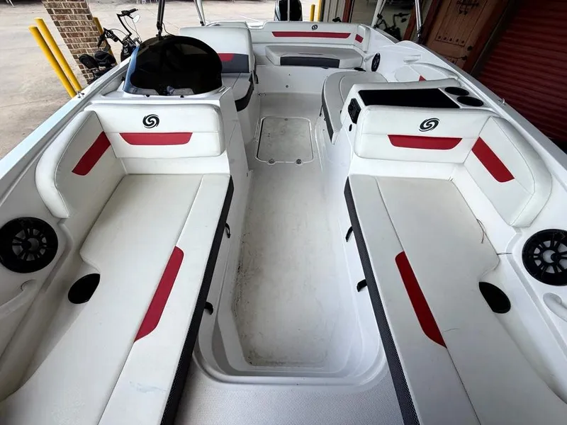 Slide: The Image of The image shows the interior of a 2020 Godfrey boat with white and red seating. - 15