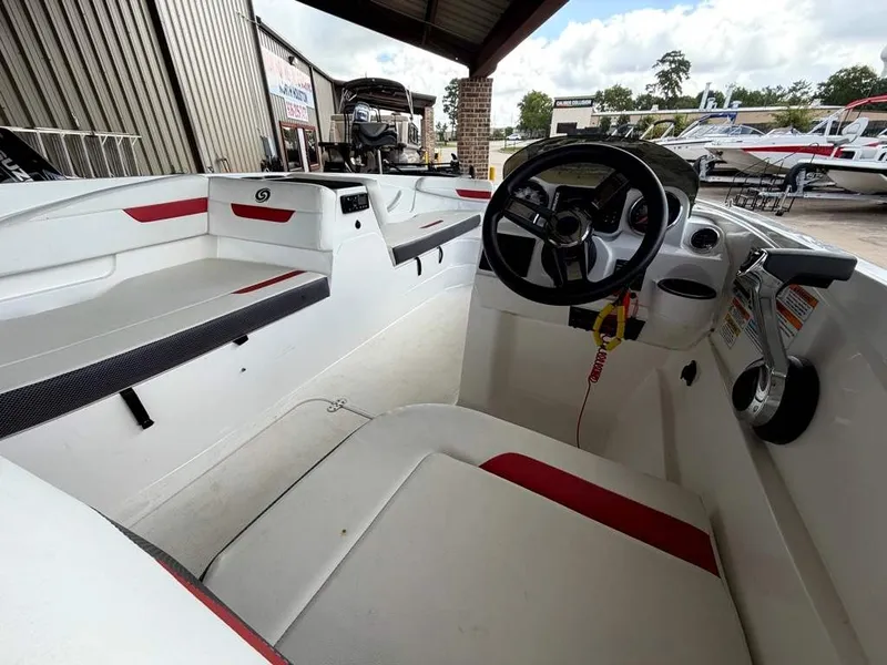 Slide: The Image of Interior view of a 2020 Godfrey boat with white and red seating and a steering console. - 10