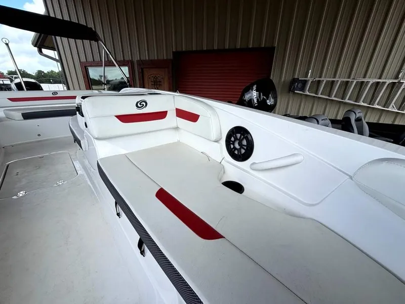 Slide: The Image of A modern pontoon boat with white and red upholstery, speakers, and a black bimini top. - 17