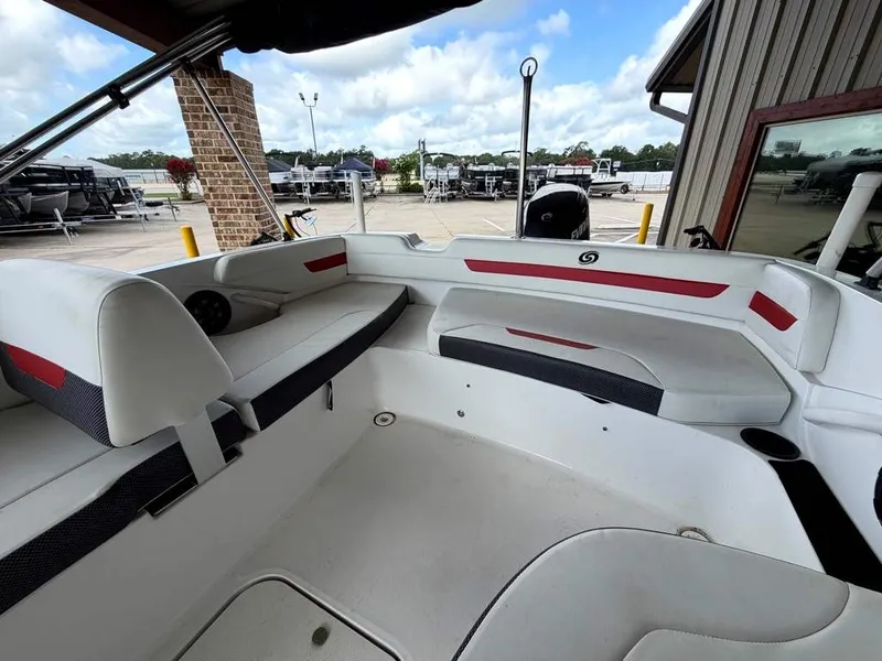 Slide: The Image of The image shows the interior of a 2020 Godfrey boat with white and red seating. - 13