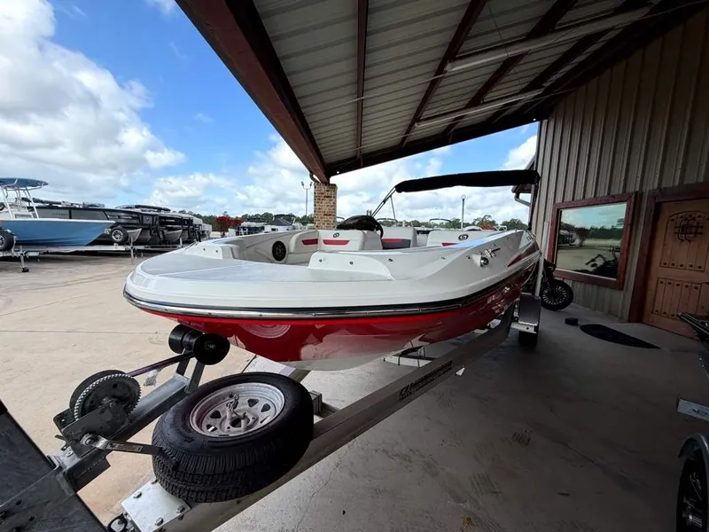 Slide: The Image of A red and white 2020 Godfrey boat on a trailer in a covered area. - 7
