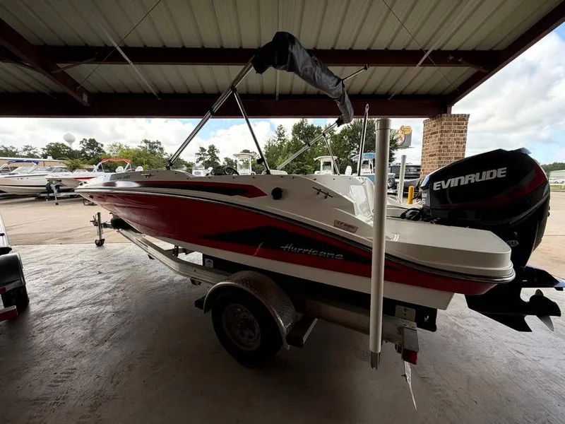 Slide: The Image of A red 2020 Godfrey boat sits on a trailer in a covered area. - 5