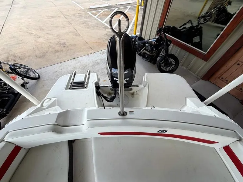 Slide: The Image of A 2020 Godfrey boat with an outboard motor, parked in a lot. - 19