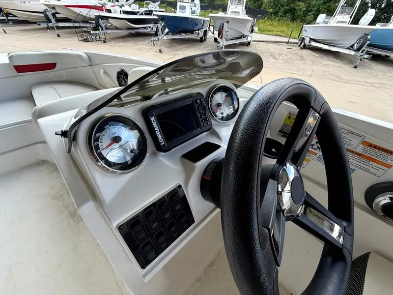 Slide: The Image of The image shows the helm of a 2020 Godfrey boat with gauges and a display screen. - 21