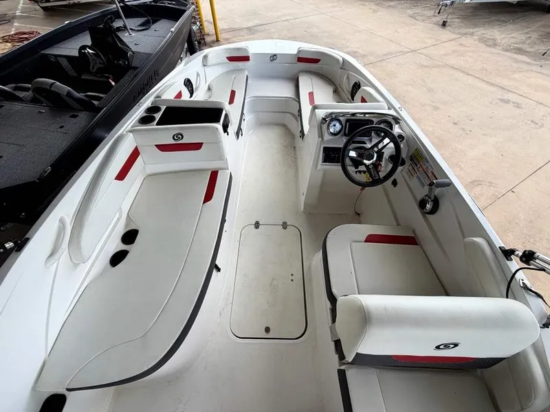 Slide: The Image of Interior view of a 2020 Godfrey boat with white and red seating and a helm station. - 9