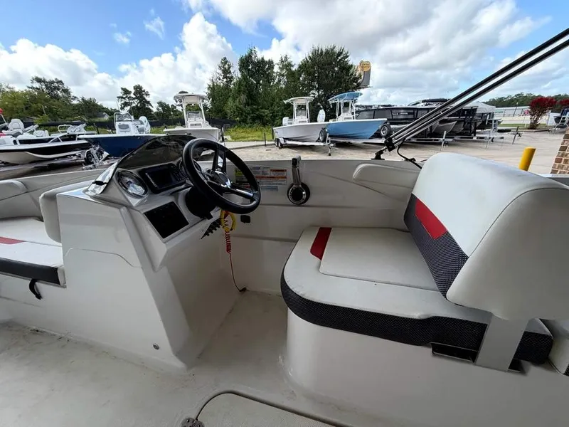 Slide: The Image of The image shows the cockpit of a 2020 Godfrey boat with a helm and seating area. - 12