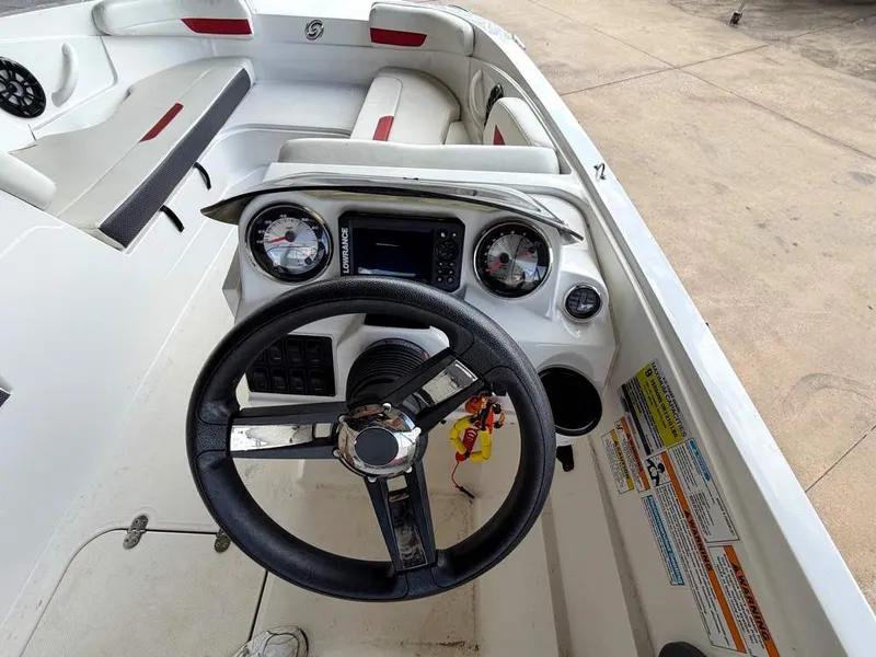 Slide: The Image of The image shows the cockpit of a 2020 Godfrey boat with a steering wheel and instruments. - 20