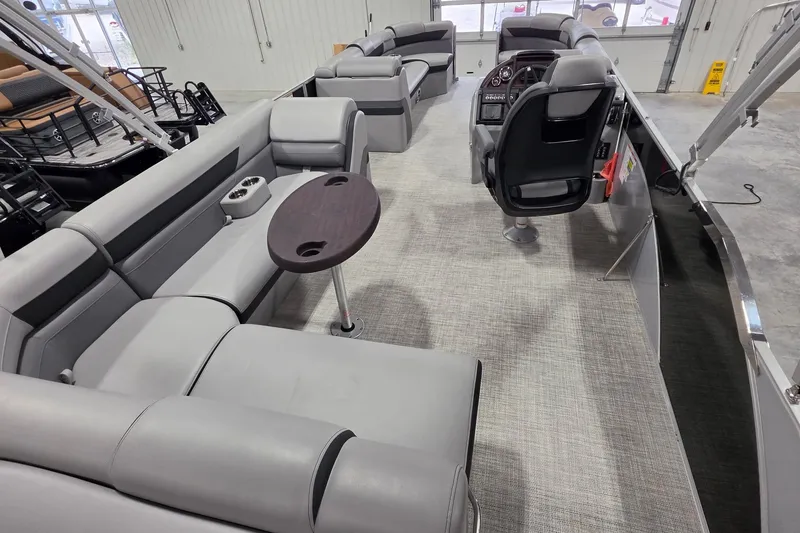 Slide: The Image of Luxurious interior of 2022 South Bay 25 CTS pontoon boat with plush seating and modern helm. - 19