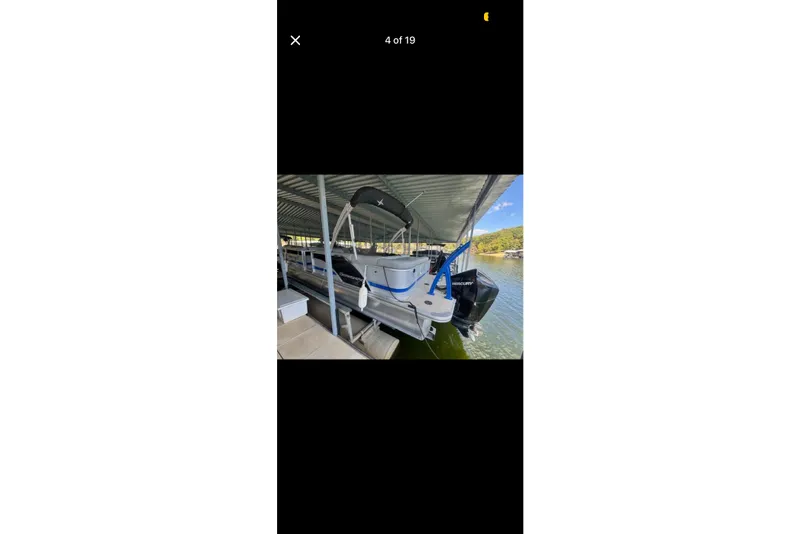 Slide: The Image of 2022 South Bay 25 CTS pontoon boat docked under a covered marina. - 4