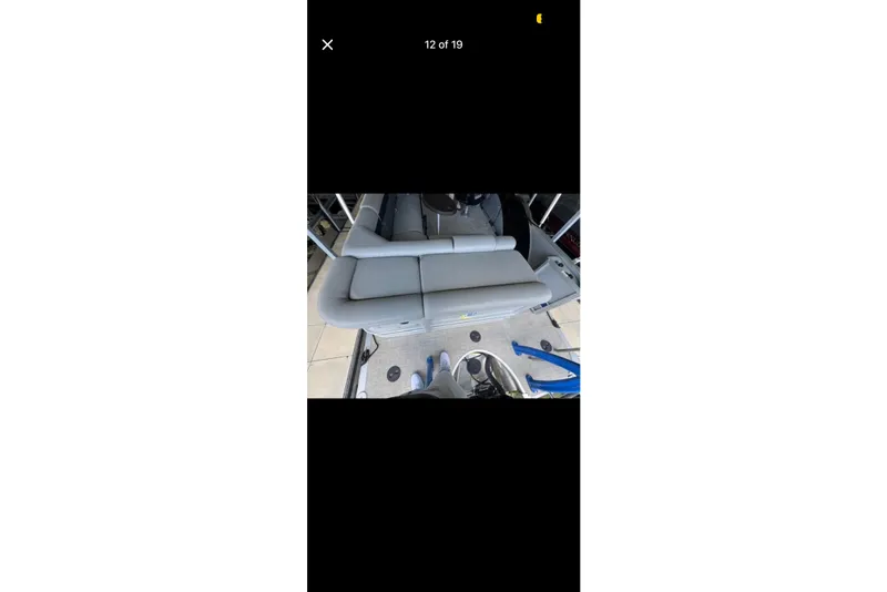 Slide: The Image of 2022 South Bay 25 CTS boat interior with gray seating and modern design. - 12