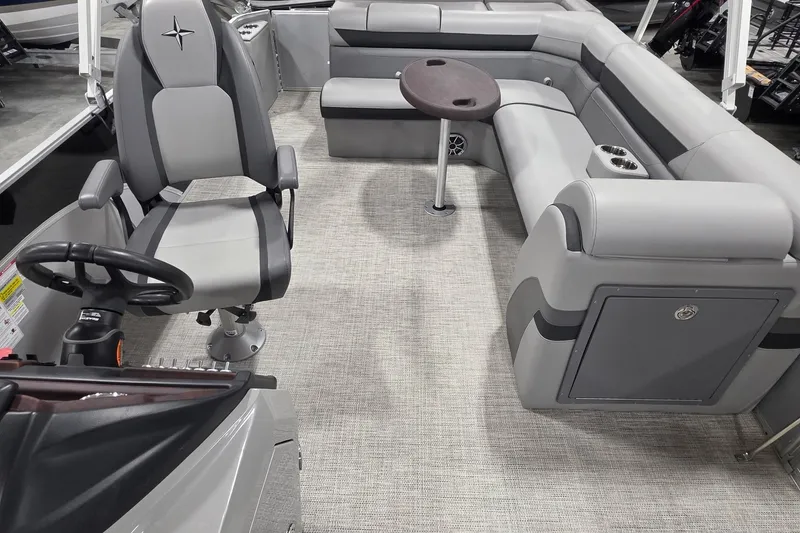 Slide: The Image of Interior of 2022 South Bay 25 CTS pontoon boat with gray seating and steering console. - 48