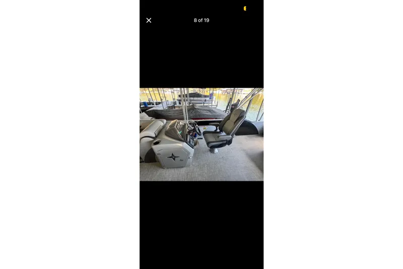 Slide: The Image of 2022 South Bay 25 CTS boat interior with captain's chair and control panel. - 8