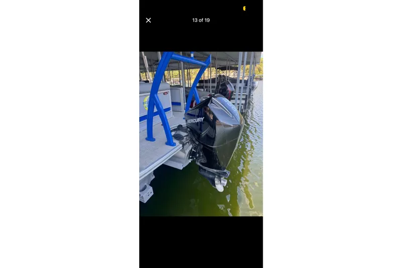 Slide: The Image of 2022 South Bay 25 CTS boat with Mercury outboard motor docked on water. - 13