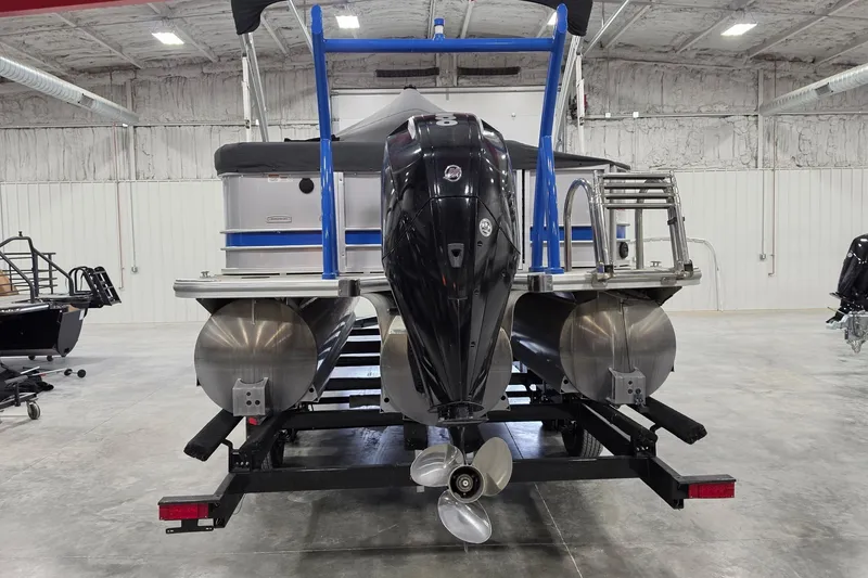 Slide: The Image of 2022 South Bay 25 CTS pontoon boat with outboard motor in a warehouse setting. - 29
