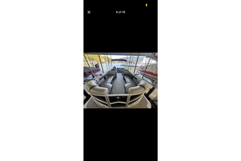 Slide: The Image of 2022 South Bay 25 CTS pontoon boat with spacious seating at a marina. - 6