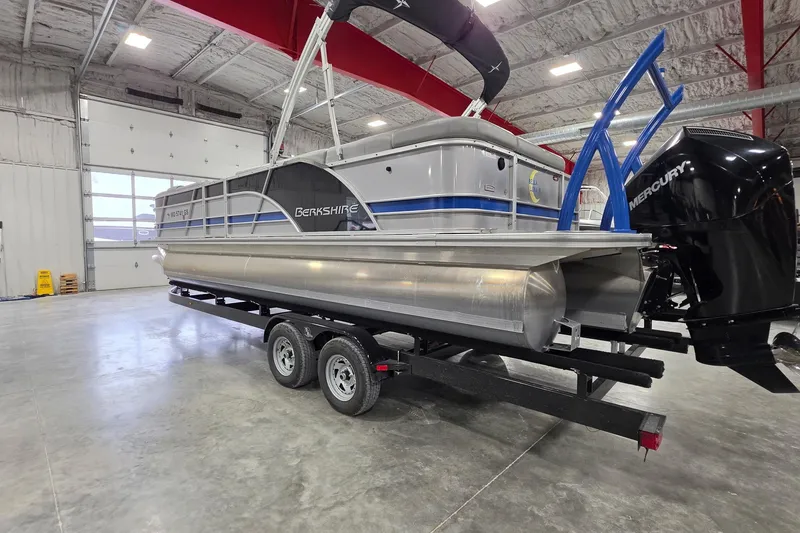 Slide: The Image of 2022 South Bay 25 CTS pontoon boat on trailer in spacious indoor facility. - 18