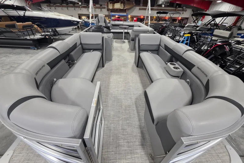Slide: The Image of 2022 South Bay 25 CTS pontoon boat interior with gray seating in showroom. - 72