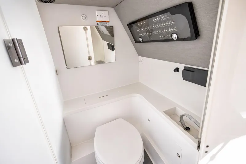 Slide: The Image of 2021 Axopar Brabus 37 Sun-Top boat bathroom with modern fixtures and control panel. - 25