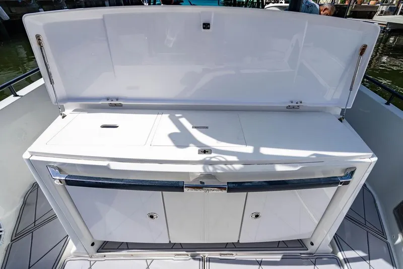 Slide: The Image of 2021 Axopar Brabus 37 Sun-Top boat interior with open storage compartment. - 19