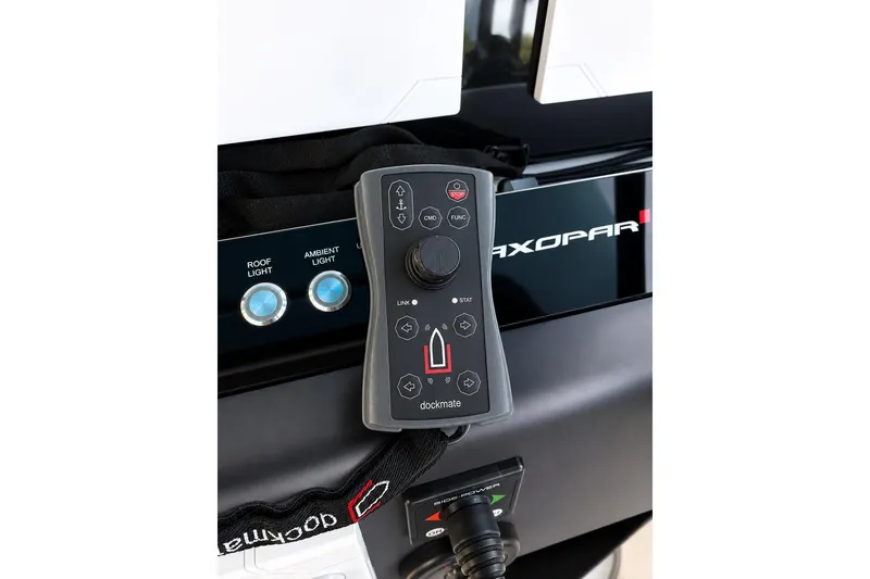 Slide: The Image of Control panel of 2021 Axopar Brabus 37 Sun-Top with Dockmate remote and light switches. - 29