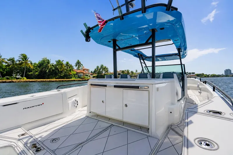 Slide: The Image of 2021 Axopar Brabus 37 Sun-Top boat on water, featuring sleek design and modern amenities. - 21