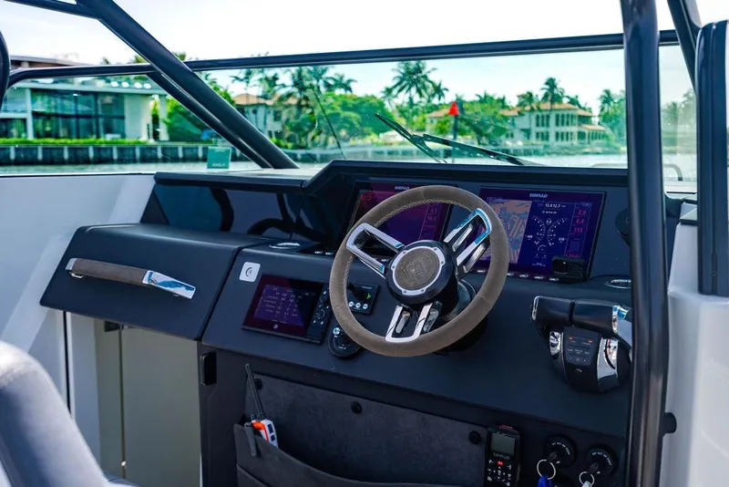 Slide: The Image of Interior view of 2021 Axopar Brabus 37 Sun-Top boat cockpit with modern controls. - 16