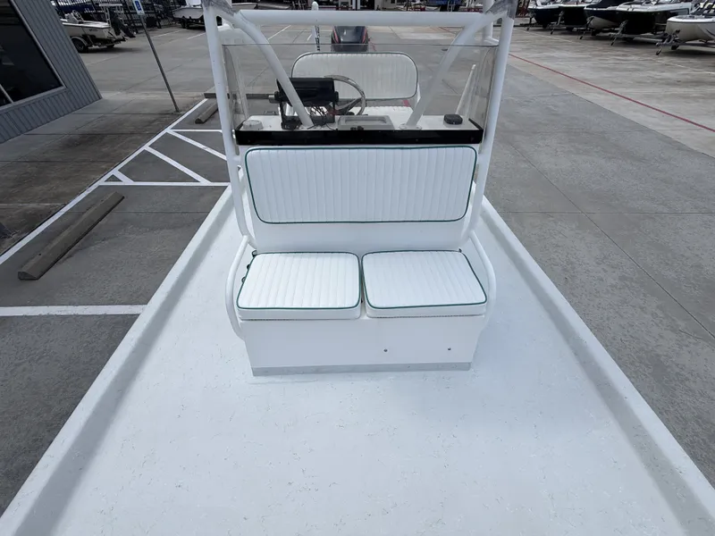 Slide: The Image of The image shows the cockpit of a Mowdy C-25 boat with white cushioned seats. - 25