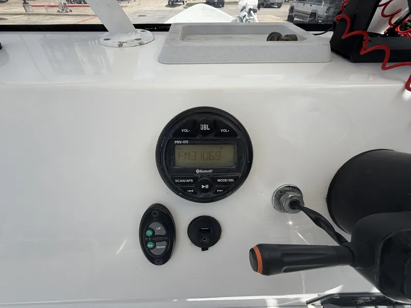 Slide: The Image of The image shows the dashboard of a Mowdy C-25 boat with a JBL radio. - 16
