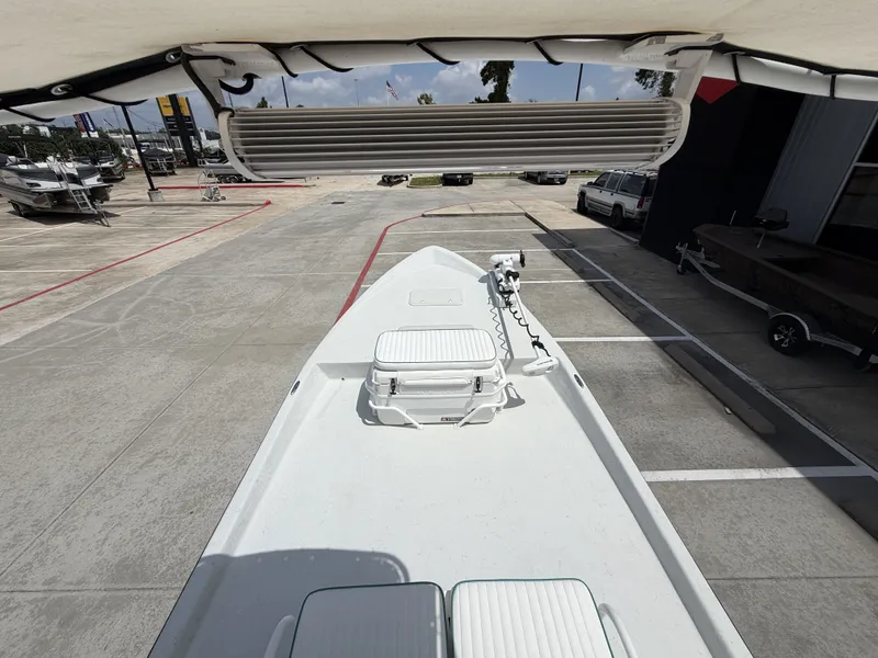 Slide: The Image of The image shows the deck of a 2015 Mowdy C-25 boat parked in a lot. - 17