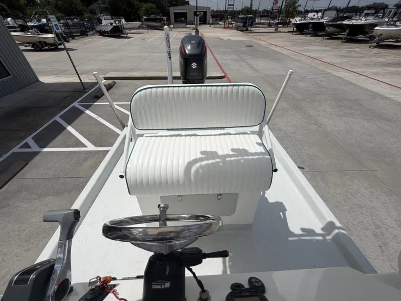 Slide: The Image of The image shows the cockpit of a 2015 Mowdy C-25 boat with a white bench seat. - 21