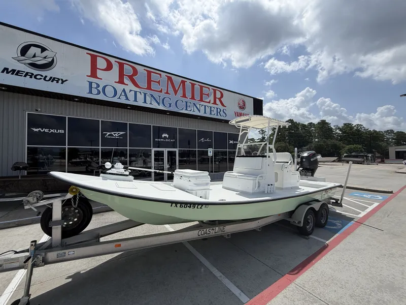 Slide: The Image of A 2015 Mowdy C-25 boat on a trailer outside a boating center. - 3