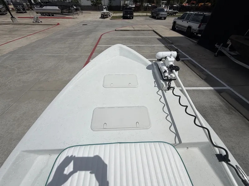 Slide: The Image of The image shows the bow of a 2015 Mowdy C-25 boat with a mounted motor. - 22