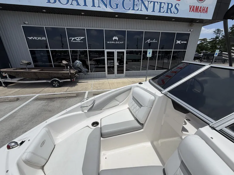Slide: The Image of The image shows the cockpit of a 2019 Regal 1900ES SURF boat with gray and white seating. - 20