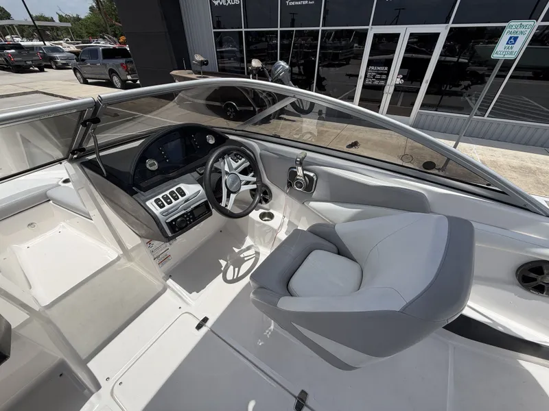 Slide: The Image of The image shows the cockpit of a 2019 Regal 1900ES SURF boat. It features a modern steering wheel and a sleek dashboard. - 14