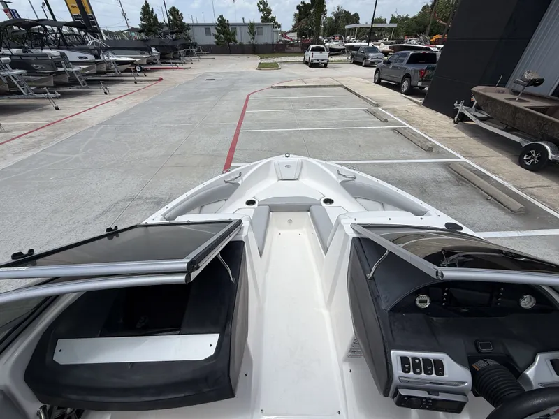 Slide: The Image of The image shows the cockpit of a 2019 Regal 1900ES SURF boat parked in a lot. - 18