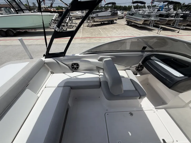 Slide: The Image of The image shows the cockpit of a 2019 Regal 1900ES SURF boat with white upholstery. - 13