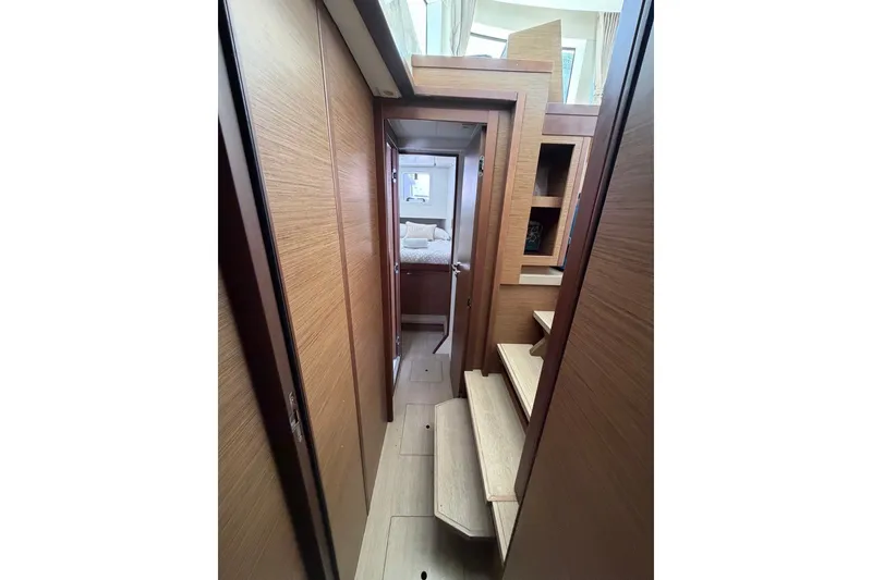 Slide: The Image of Interior hallway of 2020 Lagoon 40 catamaran with wooden finishes and steps. - 14