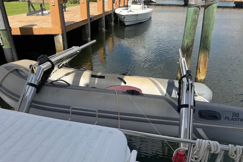 Slide: The Image of Inflatable dinghy docked beside a 2020 Lagoon 40 catamaran. - 35