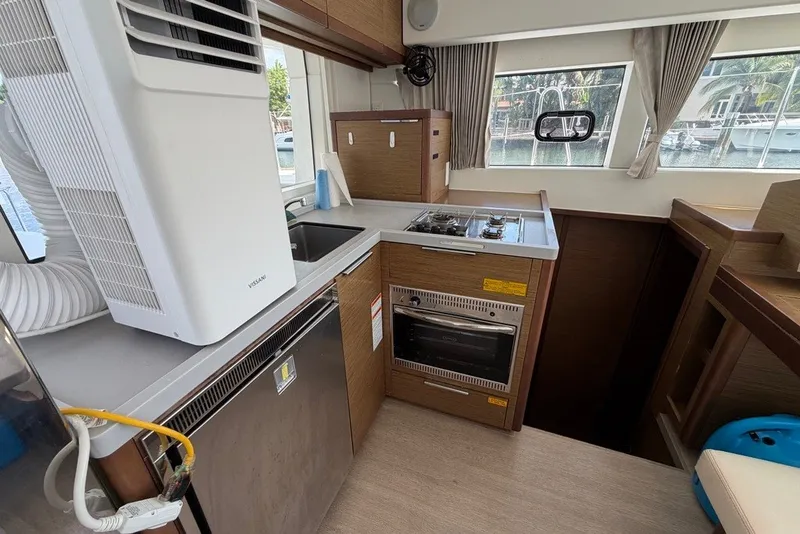 Slide: The Image of Modern kitchen inside a 2020 Lagoon 40 catamaran, featuring appliances and ample natural light. - 6
