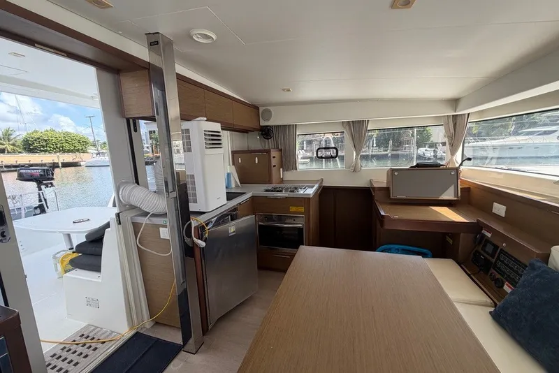 Slide: The Image of Interior of 2020 Lagoon 40 catamaran with modern kitchen and marina view. - 5