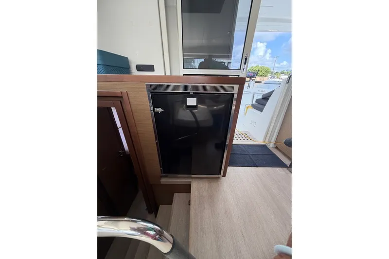Slide: The Image of Interior view of a 2020 Lagoon 40 yacht, featuring a compact refrigerator. - 7