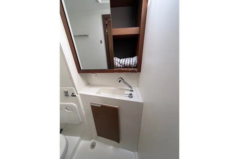 Slide: The Image of Compact bathroom in 2020 Lagoon 40 yacht with sink, mirror, and storage shelves. - 21