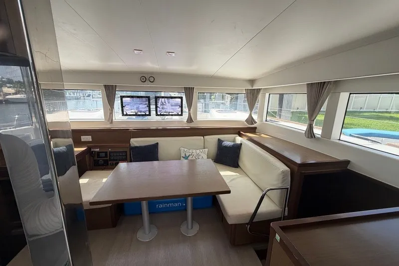 Slide: The Image of Interior of 2020 Lagoon 40 catamaran with cozy seating and large windows. - 3