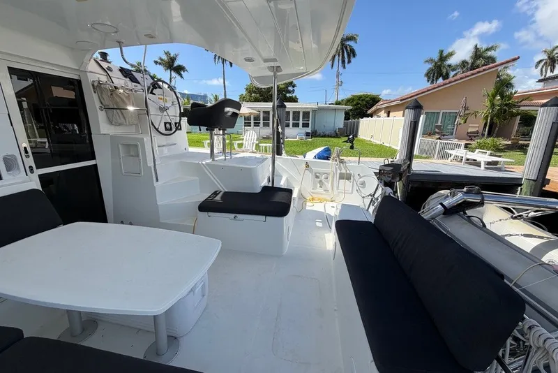 Slide: The Image of Spacious deck of 2020 Lagoon 40 catamaran with seating and steering wheel. - 30