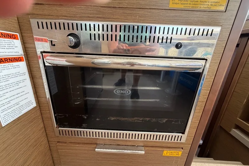 Slide: The Image of Built-in oven on Lagoon 40 yacht, 2020 model, with safety warnings displayed. - 10