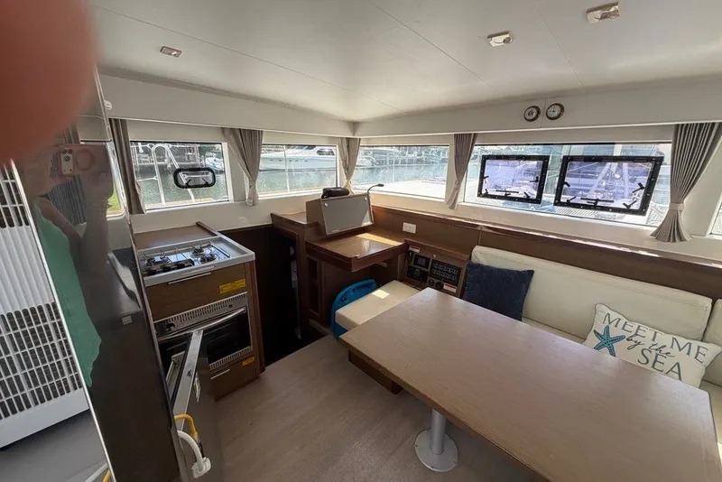 Slide: The Image of Interior of 2020 Lagoon 40 catamaran with dining area and kitchen. - 4