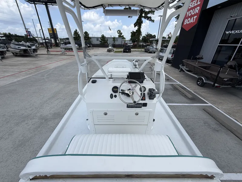 Slide: The Image of The image shows the cockpit of a 2015 Mowdy C-25 boat parked in a lot. - 15
