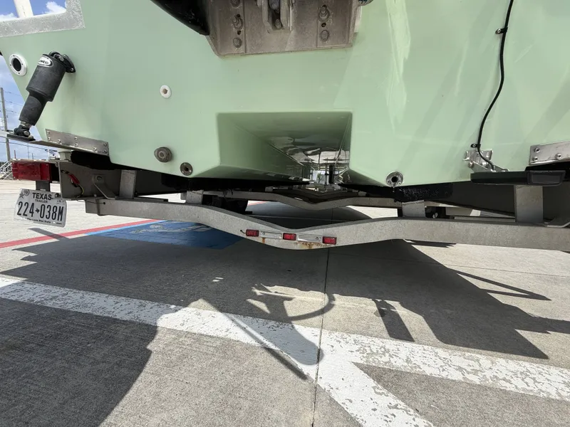 Slide: The Image of The image shows the stern of a Mowdy C-25 boat on a trailer. - 10